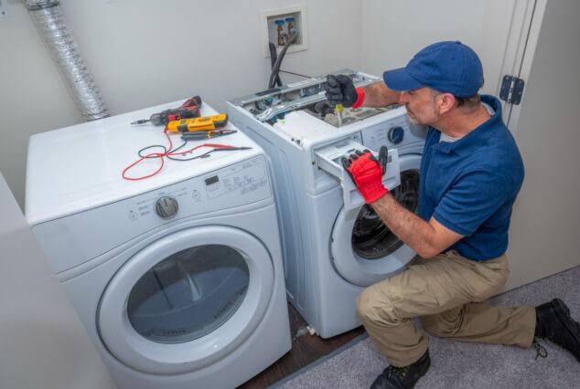 tools and parts laid out for a fridge repair in Larchmont